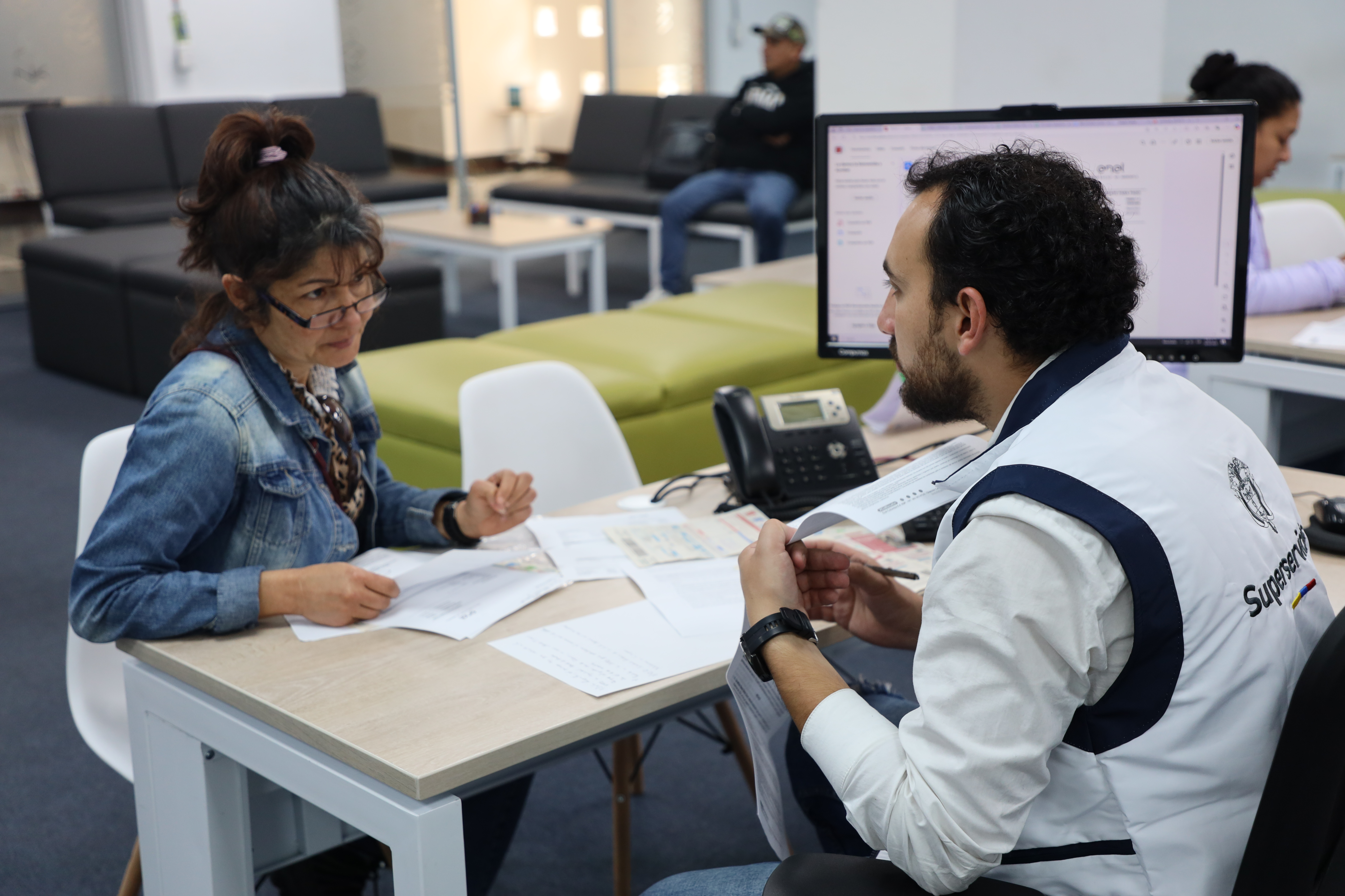 Funcionario de la Superservicios atendiendo a un usuario con una solicitud de asesoría sobre un servicio público 